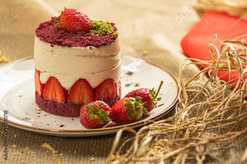 Red velvet decorated with cream and strawberries