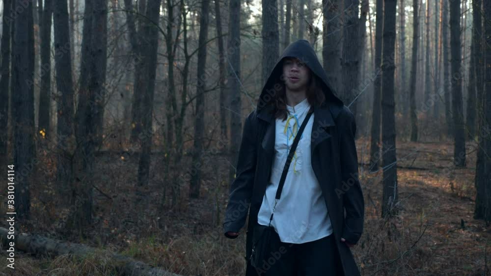 Tired Wanderer wearing Black Cloak with Cowl Stops and Rests in Misty Wood. Monk Pilgrim. Autumn Morning. 2x Slow motion 60 fps 4K Tired Wanderer wearing Black Cloak with Cowl Stops and Rests in Misty Wood. Monk Pilgrim. Autumn Morning. 2x Slow motion 60 fps 4K