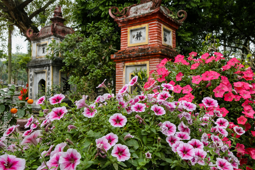 Flowers and sculptures at the one pillar pagoda in Hanoi Vietnam