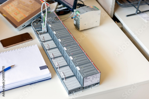 A programmable logic controller (PLC) or programmable controller. It is an industrial digital computer which has been ruggedized and adapted for the control of manufacturing processes.