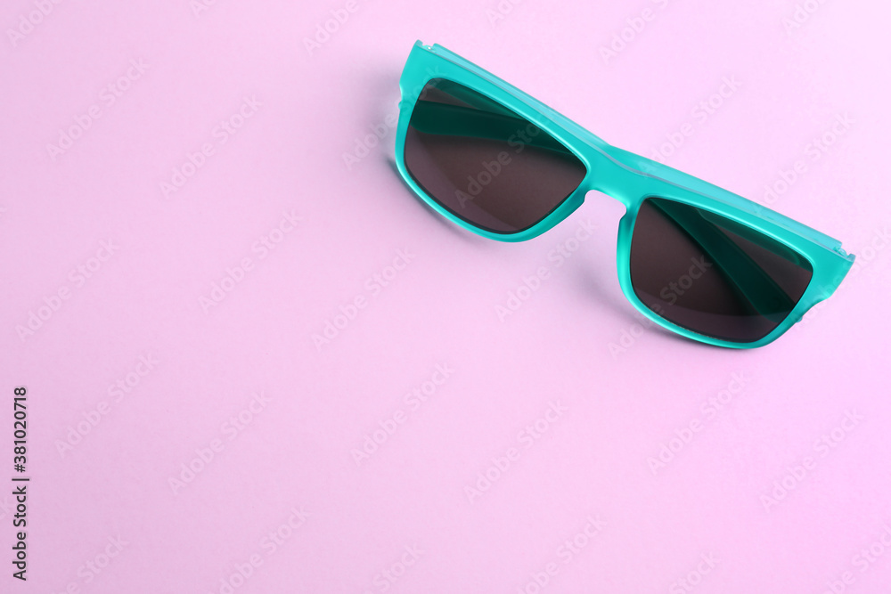 Stylish sunglasses on light violet background, top view. Space for text Stylish sunglasses on light violet background, top view. Space for text