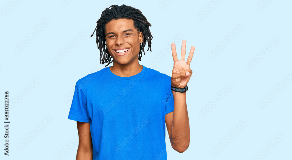 Young african american man wearing casual clothes showing and pointing up with fingers number three while smiling confident and happy. Young african american man wearing casual clothes showing and pointing up with fingers number three while smiling confident and happy.