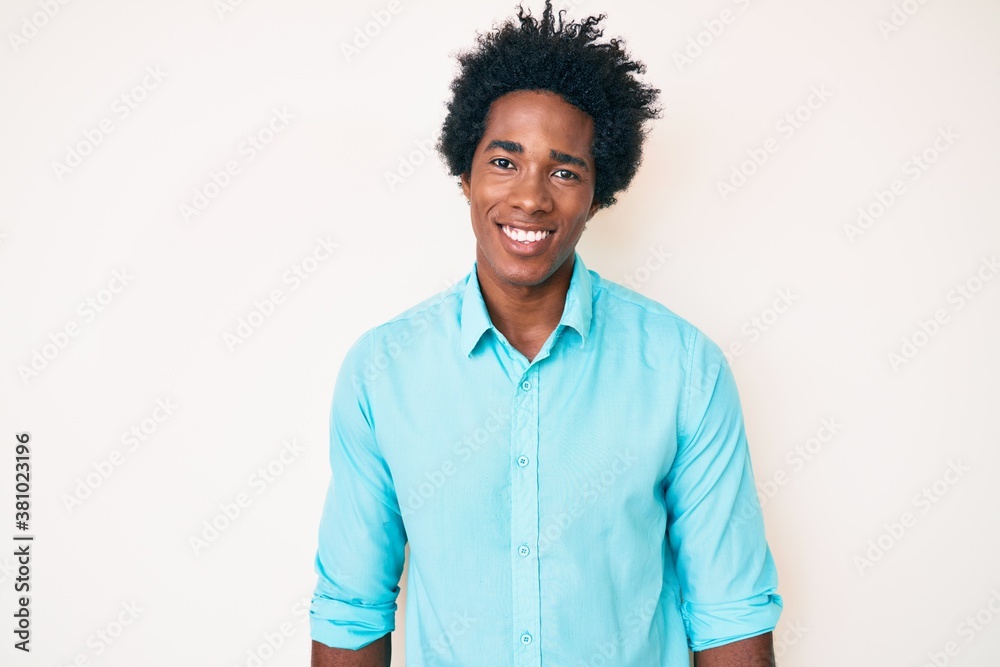 Handsome african american man with afro hair wearing casual clothes with a happy and cool smile on face. lucky person.