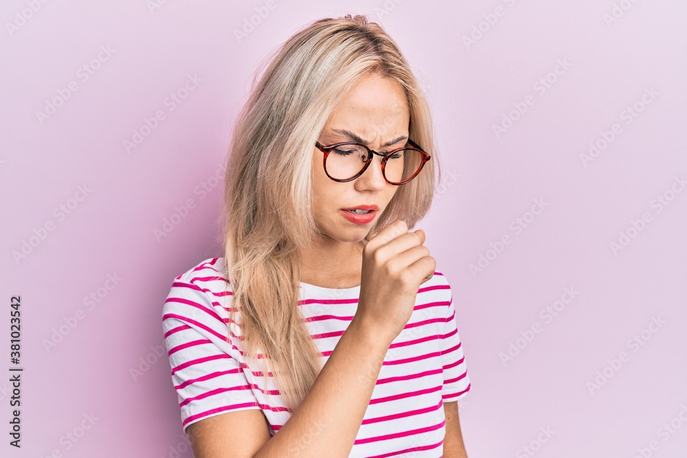 Beautiful caucasian blonde girl wearing casual clothes and glasses feeling unwell and coughing as symptom for cold or bronchitis. health care concept. Beautiful caucasian blonde girl wearing casual clothes and glasses feeling unwell and coughing as symptom for cold or bronchitis. health care concept.