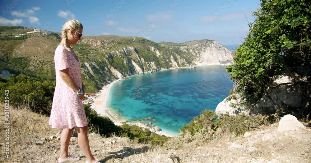 Woman traveller on top of mountain looking at beautiful sea bay celebrating scenic landscape enjoying vacation travel adventure nature. Woman traveller on top of mountain looking at beautiful sea bay celebrating scenic landscape enjoying vacation travel adventure nature.