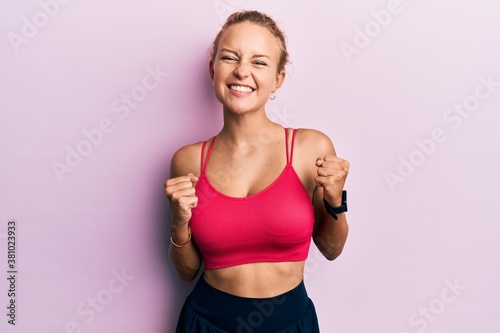 Beautiful caucasian woman wearing sportswear excited for success with arms raised and eyes closed celebrating victory smiling. winner concept. © Krakenimages.com