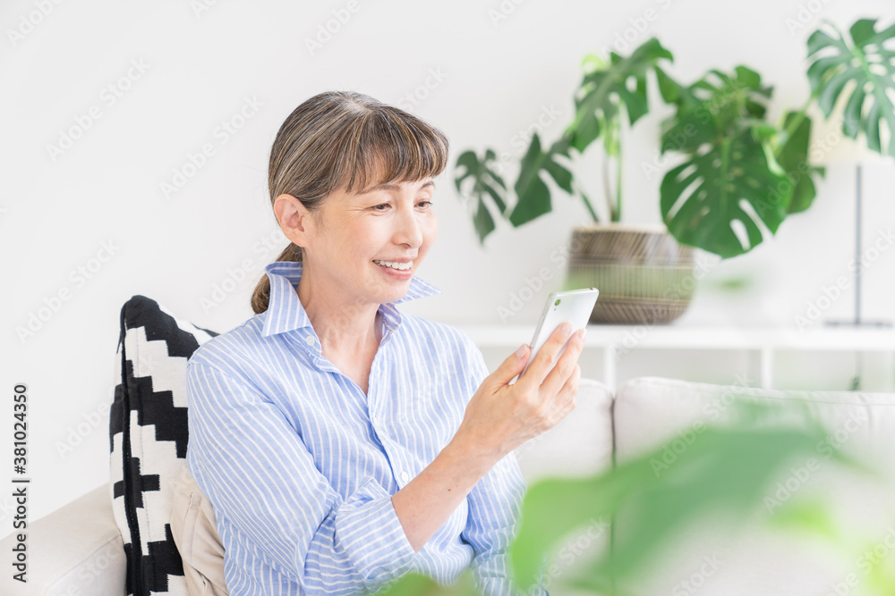 スマートフォンを見るシニア女性 スマートフォンを見るシニア女性
