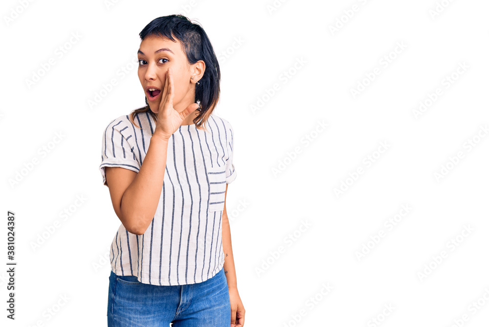 Young woman wearing casual clothes hand on mouth telling secret rumor, whispering malicious talk conversation Young woman wearing casual clothes hand on mouth telling secret rumor, whispering malicious talk conversation