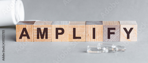 Canvas Print amplify inscription word on wooden cube blocks on a table