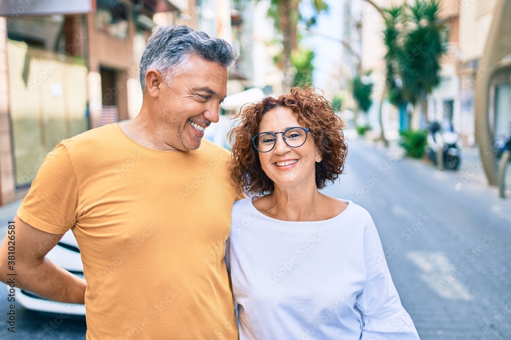 Middle age couple smiling happy standing at street of city. Middle age couple smiling happy standing at street of city.