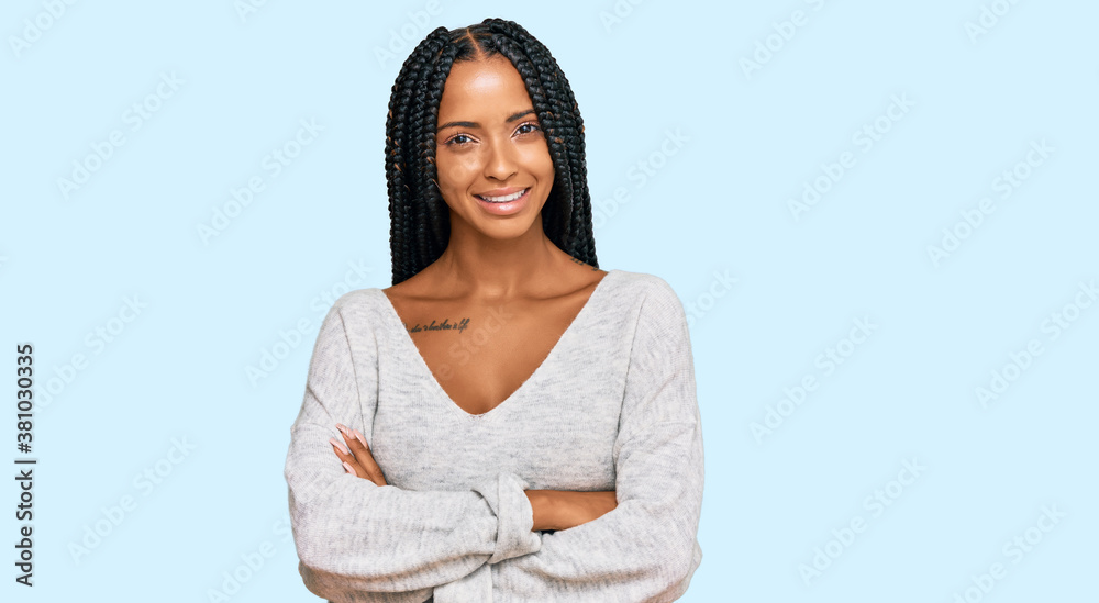 Beautiful hispanic woman wearing casual clothes happy face smiling with crossed arms looking at the camera. positive person. Beautiful hispanic woman wearing casual clothes happy face smiling with crossed arms looking at the camera. positive person.