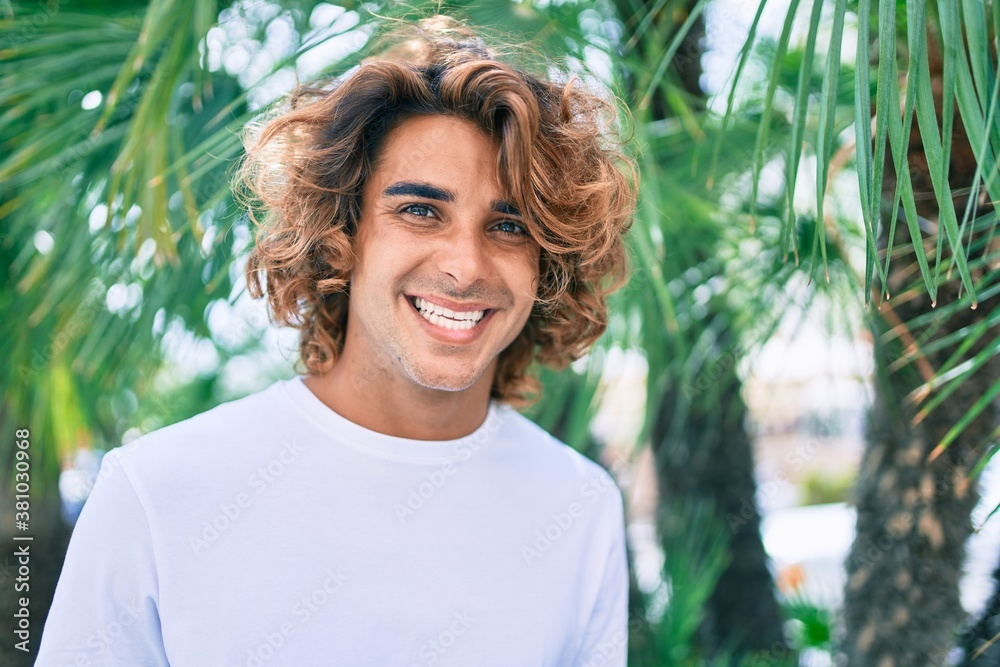 Young handsome hispanic man smiling happy walking at street of city Young handsome hispanic man smiling happy walking at street of city
