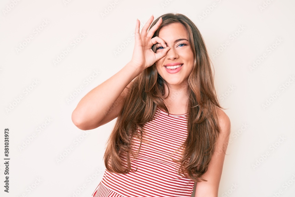 Beautiful young caucasian woman wearing casual clothes smiling happy doing ok sign with hand on eye looking through fingers Beautiful young caucasian woman wearing casual clothes smiling happy doing ok sign with hand on eye looking through fingers