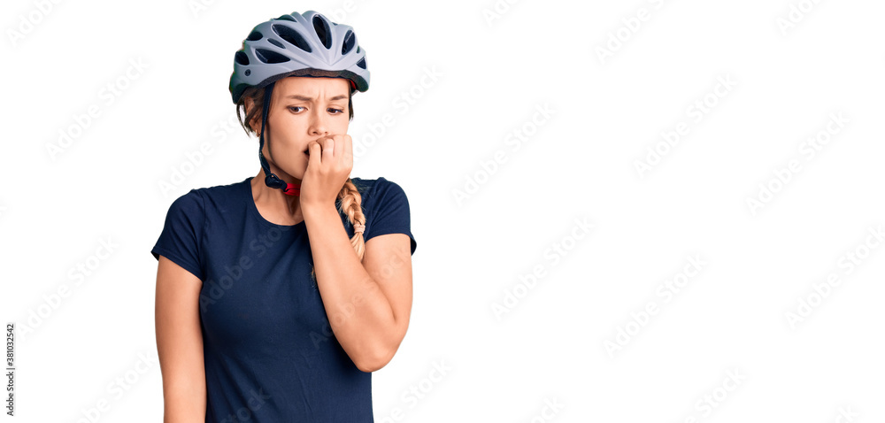 Beautiful caucasian woman wearing bike helmet looking stressed and nervous with hands on mouth biting nails. anxiety problem. Beautiful caucasian woman wearing bike helmet looking stressed and nervous with hands on mouth biting nails. anxiety problem.