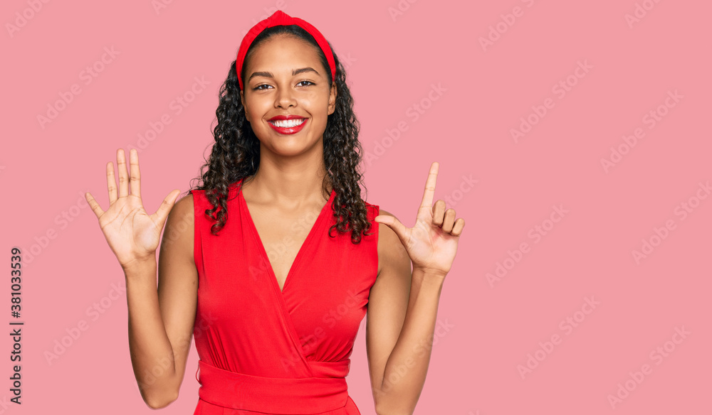 Young african american girl wearing elegant and sexy look showing and pointing up with fingers number seven while smiling confident and happy. Young african american girl wearing elegant and sexy look showing and pointing up with fingers number seven while smiling confident and happy.