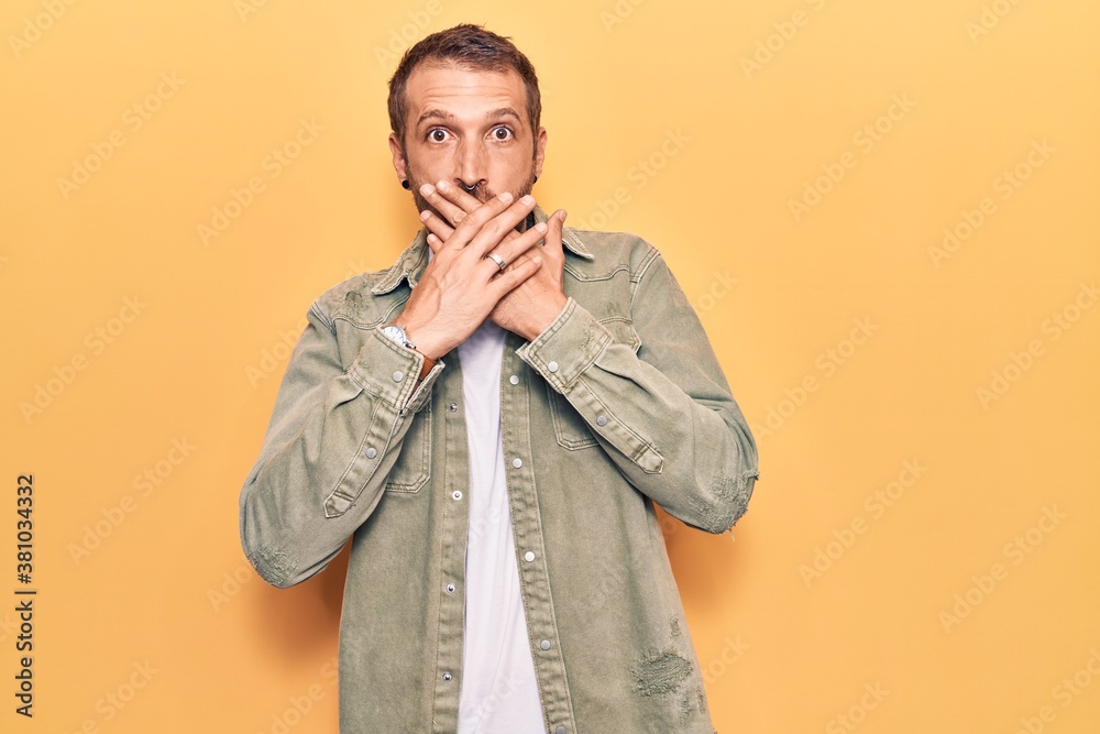 Young handsome man wearing casual clothes shocked covering mouth with hands for mistake. secret concept. Young handsome man wearing casual clothes shocked covering mouth with hands for mistake. secret concept.
