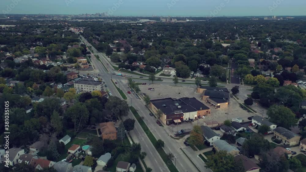Aerial drone view of American suburban neighborhood at night time. Establishing shot of America's suburb. Residential houses, street lights, road, cars Aerial drone view of American suburban neighborhood at night time. Establishing shot of America's suburb. Residential houses, street lights, road, cars