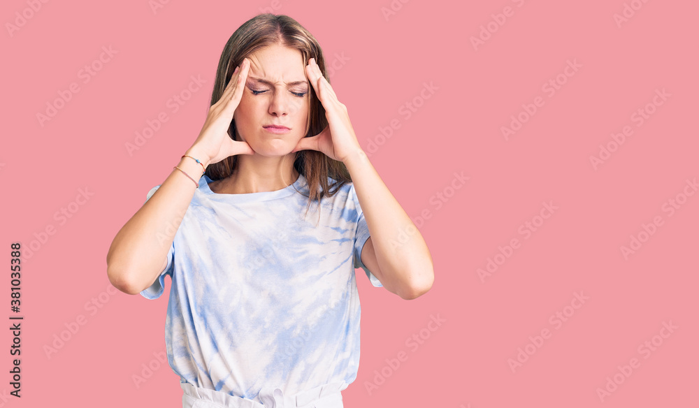 Φωτογραφία Young beautiful blonde woman wearing tye die tshirt suffering from headache desperate and stressed because pain and migraine