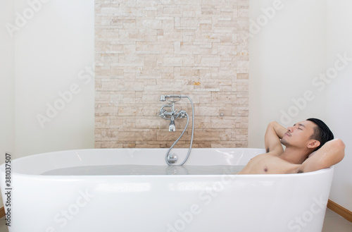 young asian man relax and spa in bathtub.