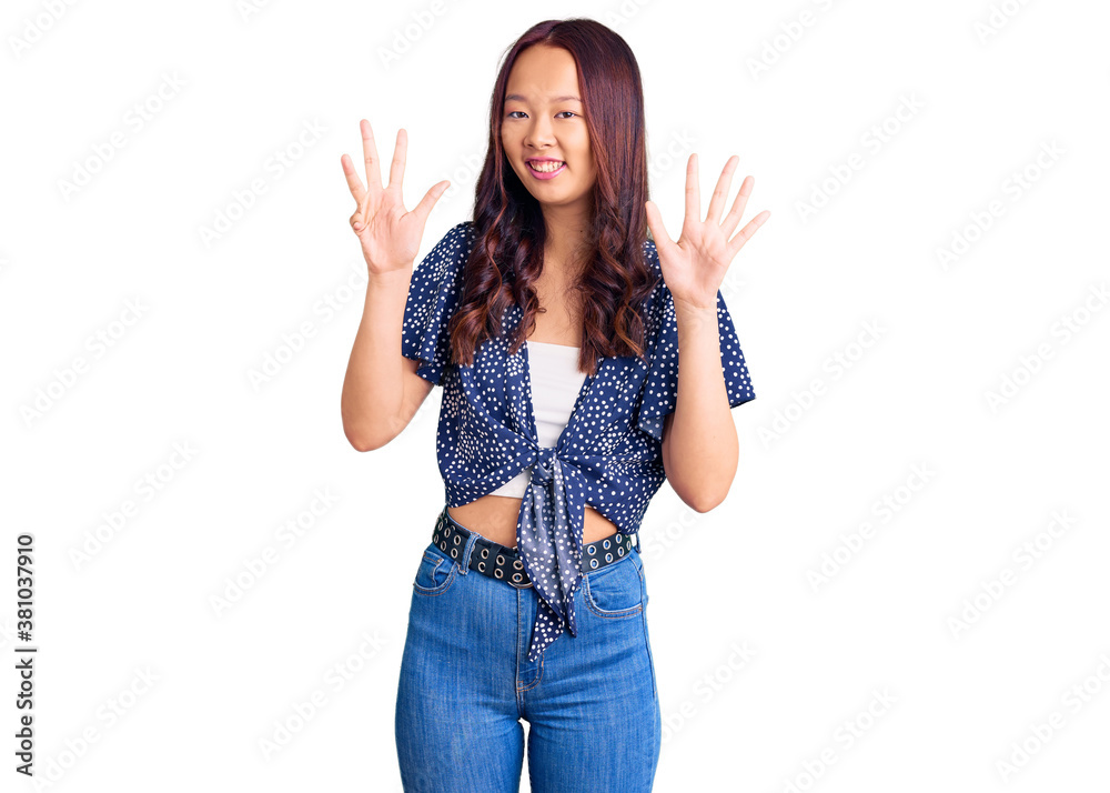 Young beautiful chinese girl wearing casual clothes showing and pointing up with fingers number nine while smiling confident and happy. Young beautiful chinese girl wearing casual clothes showing and pointing up with fingers number nine while smiling confident and happy.