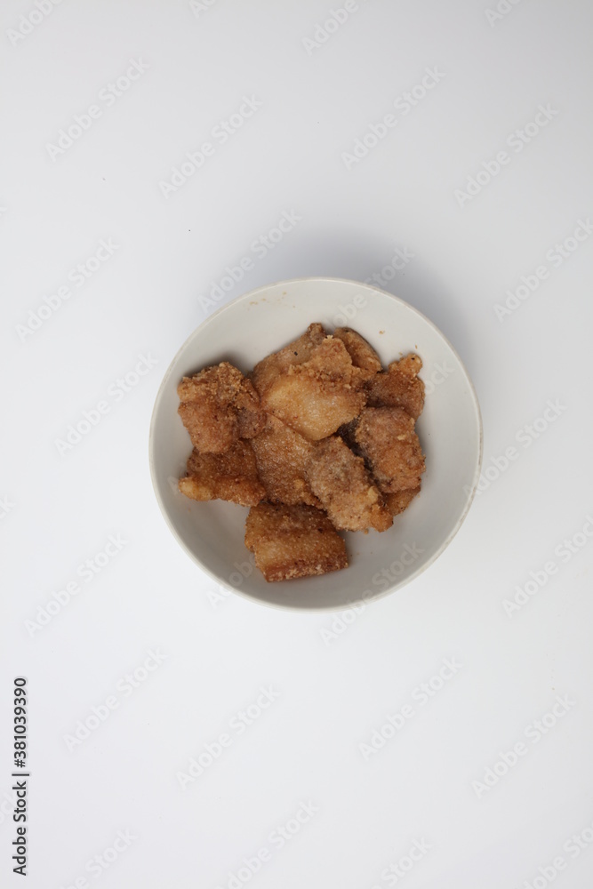 A bowl of steamed pork on a white background A bowl of steamed pork on a white background