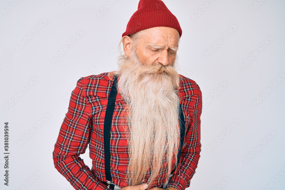 Φωτογραφία Old senior man with grey hair and long beard wearing hipster look with wool cap with hand on stomach because indigestion, painful illness feeling unwell