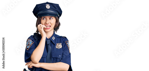 Young beautiful girl wearing police uniform looking stressed and nervous with hands on mouth biting nails. anxiety problem.