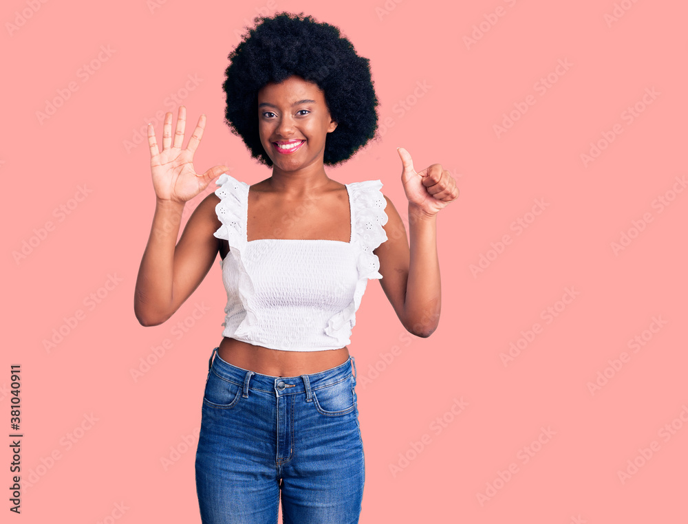 Young african american woman wearing casual clothes showing and pointing up with fingers number six while smiling confident and happy. Young african american woman wearing casual clothes showing and pointing up with fingers number six while smiling confident and happy.