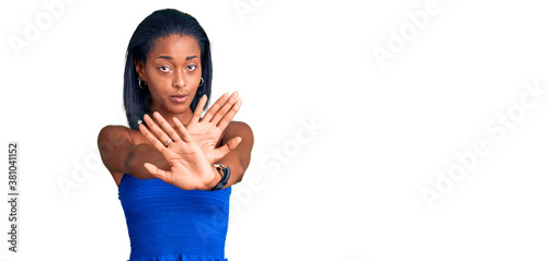 Young african american woman wearing casual summer clothes rejection expression crossing arms and palms doing negative sign, angry face photo