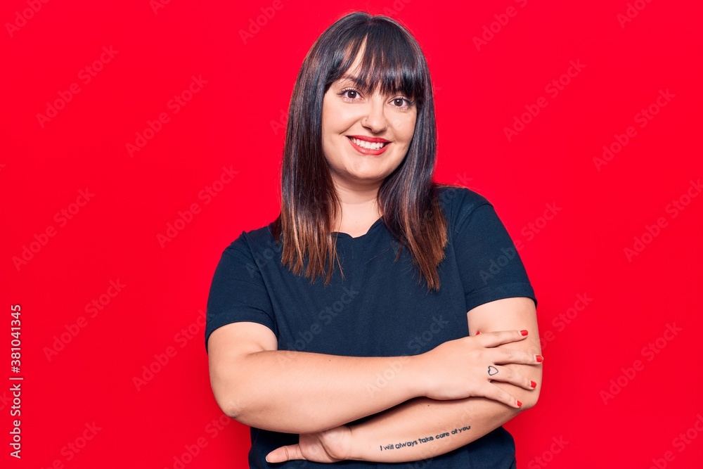 Obraz premium Young plus size woman wearing casual clothes happy face smiling with crossed arms looking at the camera. positive person.