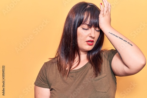 Young plus size woman wearing casual clothes surprised with hand on head for mistake, remember error. forgot, bad memory concept.