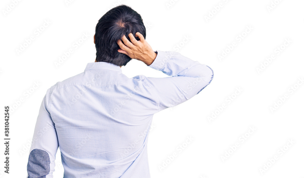 Handsome hispanic man wearing business shirt and glasses backwards thinking about doubt with hand on head Handsome hispanic man wearing business shirt and glasses backwards thinking about doubt with hand on head