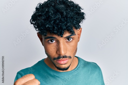 Young arab handsome man wearing casual clothes annoyed and frustrated shouting with anger, yelling crazy with anger and hand raised