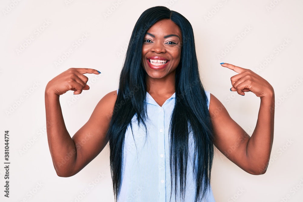 Young african american woman wearing casual clothes looking confident with smile on face, pointing oneself with fingers proud and happy. Young african american woman wearing casual clothes looking confident with smile on face, pointing oneself with fingers proud and happy.