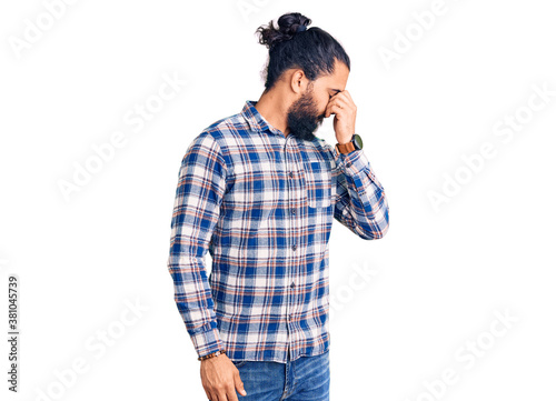 Young arab man wearing casual clothes tired rubbing nose and eyes feeling fatigue and headache. stress and frustration concept.