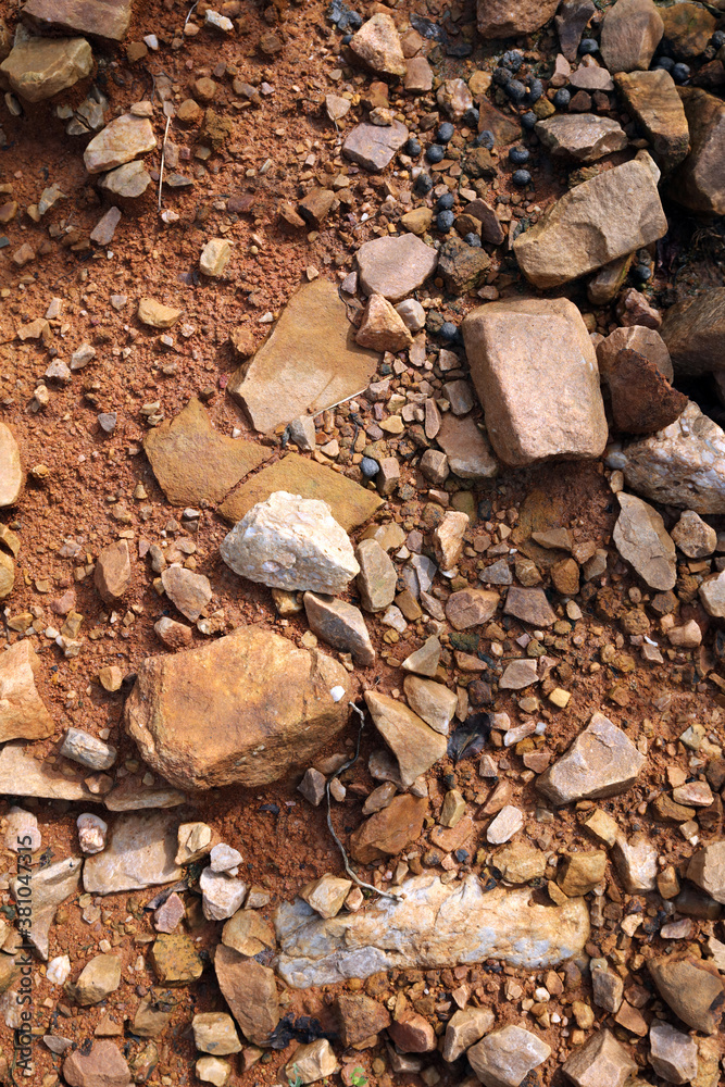 Wet ground, yellow soil, there are many small stones, details of the texture Wet ground, yellow soil, there are many small stones, details of the texture