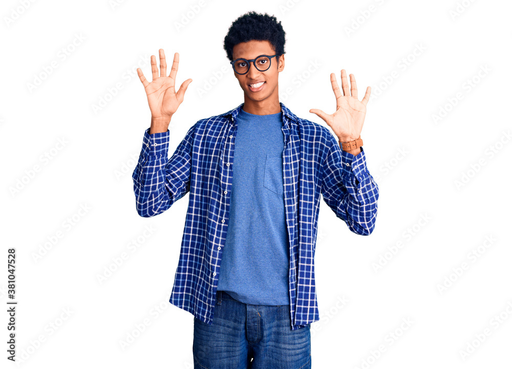 Young african american man wearing casual clothes and glasses showing and pointing up with fingers number ten while smiling confident and happy. Young african american man wearing casual clothes and glasses showing and pointing up with fingers number ten while smiling confident and happy.