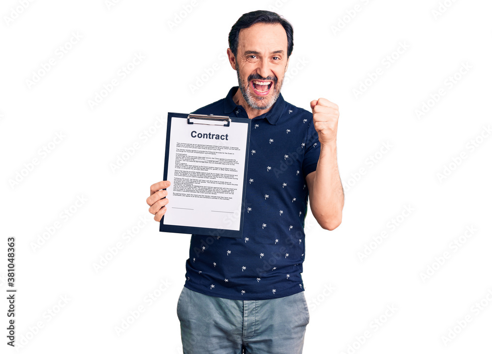 Middle age handsome man holding clipboard with contract document screaming proud, celebrating victory and success very excited with raised arms Middle age handsome man holding clipboard with contract document screaming proud, celebrating victory and success very excited with raised arms