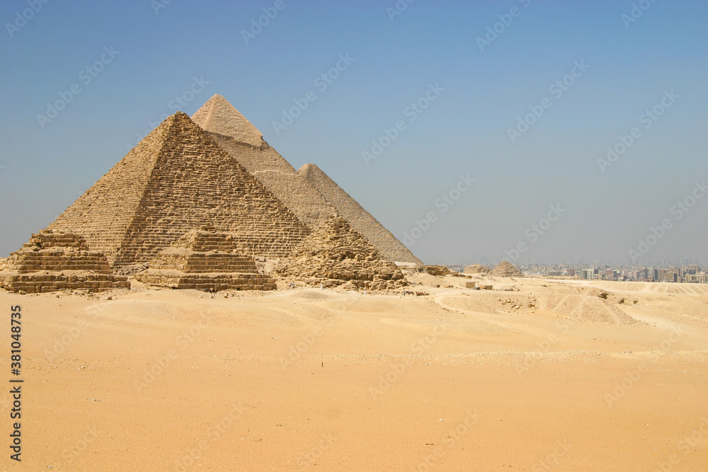 A view of the pyramids at Giza from the plateau to the south of the complex. From left to right, the three largest are: the Pyramid of Menkaure, the Pyramid of Khafre and the Great Pyramid of Khufu.
