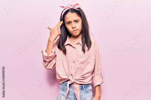 Canvas Print Beautiful child girl wearing casual clothes shooting and killing oneself pointing hand and fingers to head like gun, suicide gesture