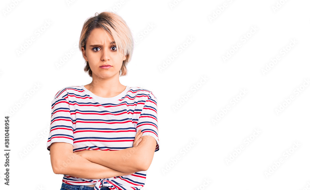 Young beautiful blonde woman wearing casual clothes skeptic and nervous, disapproving expression on face with crossed arms. negative person.