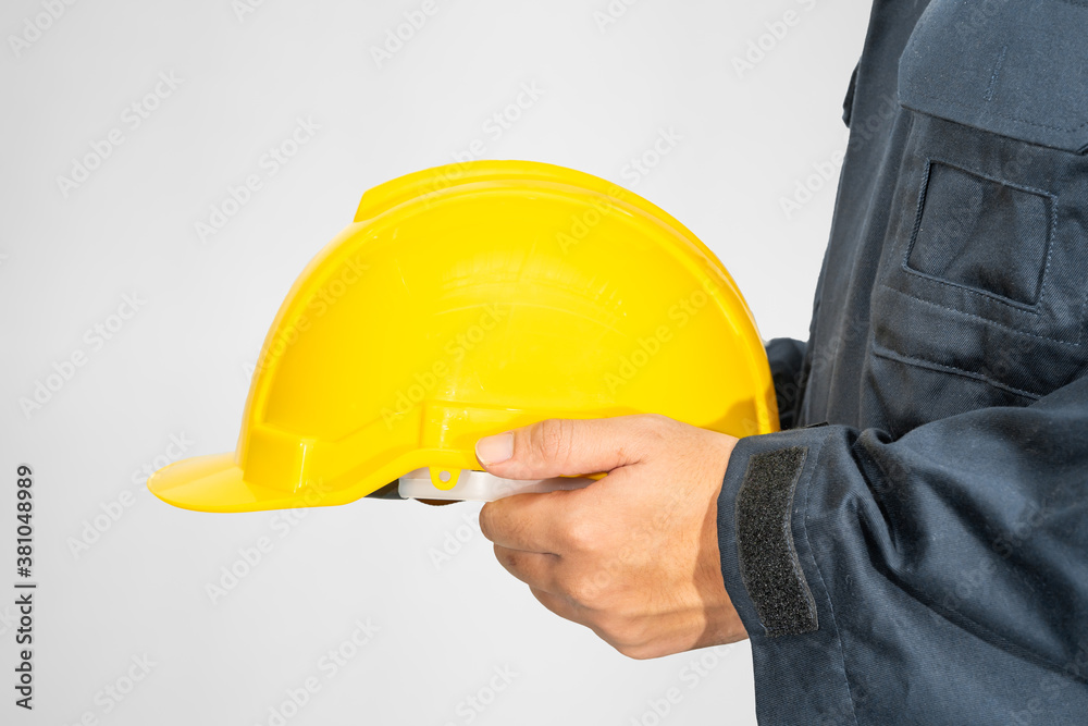 Close up Worker standing in blue coverall holding hardhat Close up Worker standing in blue coverall holding hardhat