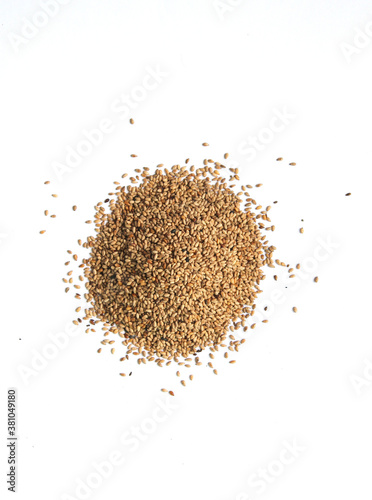 Heap of organic natural sesame seeds over isolated on white background