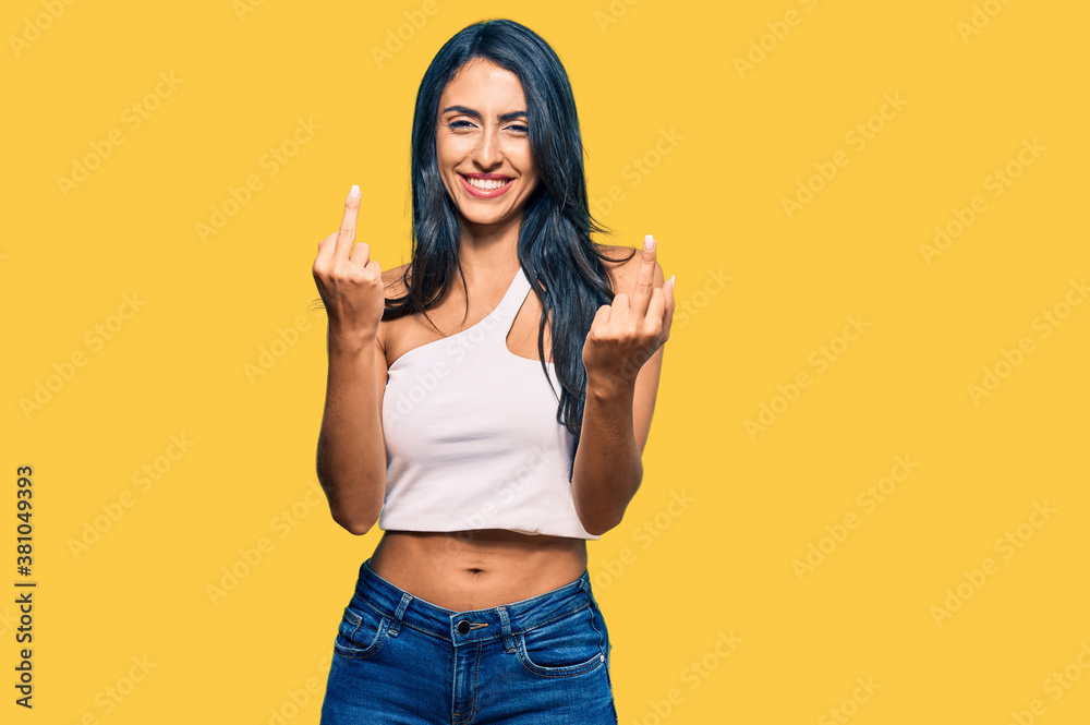 Beautiful hispanic woman wearing casual clothes showing middle finger doing fuck you bad expression, provocation and rude attitude. screaming excited Beautiful hispanic woman wearing casual clothes showing middle finger doing fuck you bad expression, provocation and rude attitude. screaming excited