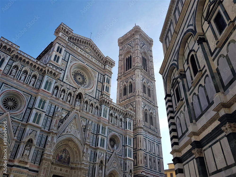 Piazza del Duomo in Florence, Italy. Cathedral of Santa Maria del Fiore and a blue sky. Campanario de Giotto tower. Florence architecture.
