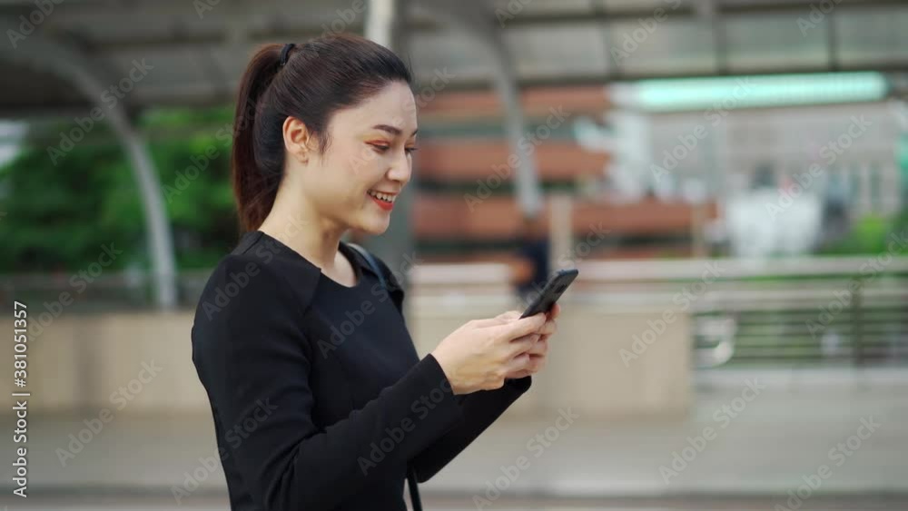 business woman walking and using her smartphone in the city business woman walking and using her smartphone in the city
