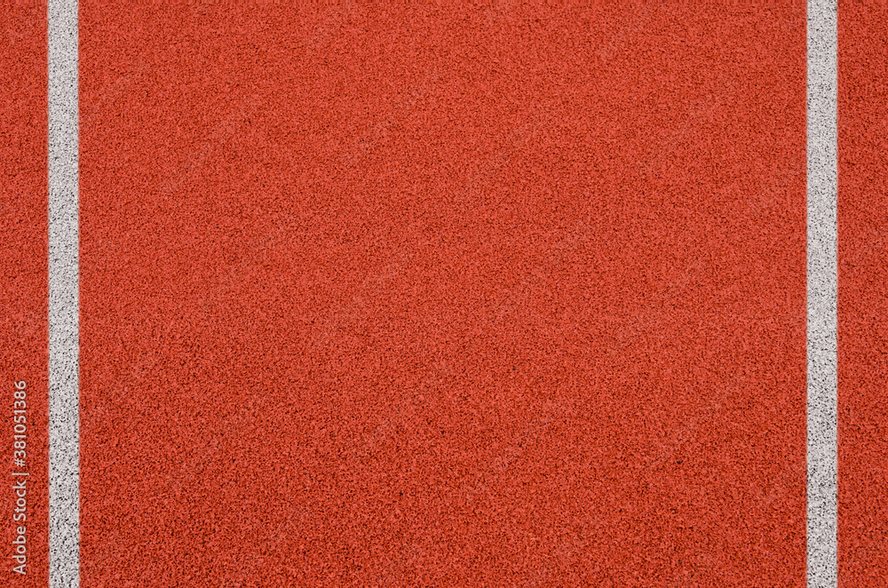 Fototapeta premium Top view of the running track rubber lanes cover texture with white line marking for background.