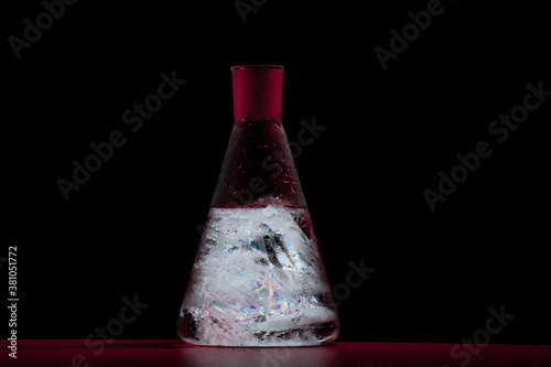 Chemistry flask neon light red. Water and ice. photo