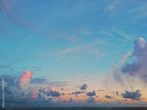 Beautiful cloudy sunset in the Caribbean Sea, the sunset produces pastel blue, orange and pink colors.