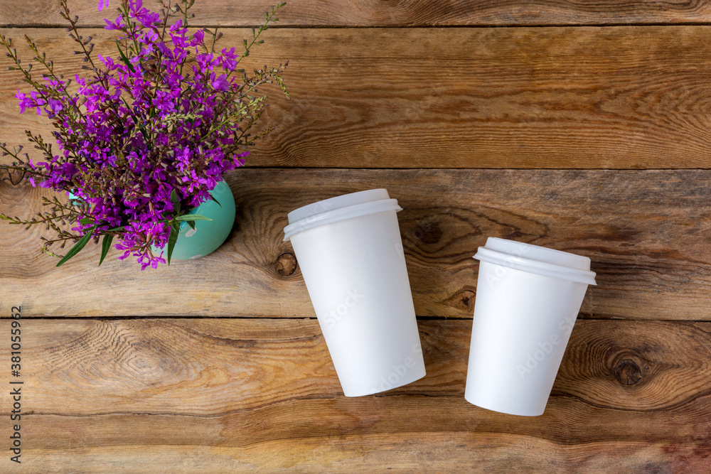Paper coffee cup mockup with purple wildflowers